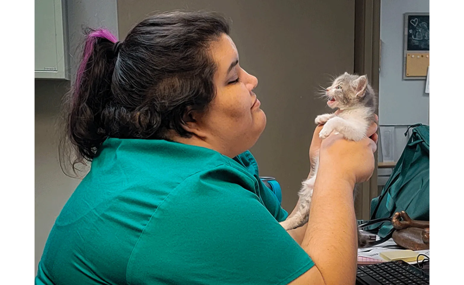 Staff Member Holding a Small Kitten in her Hands